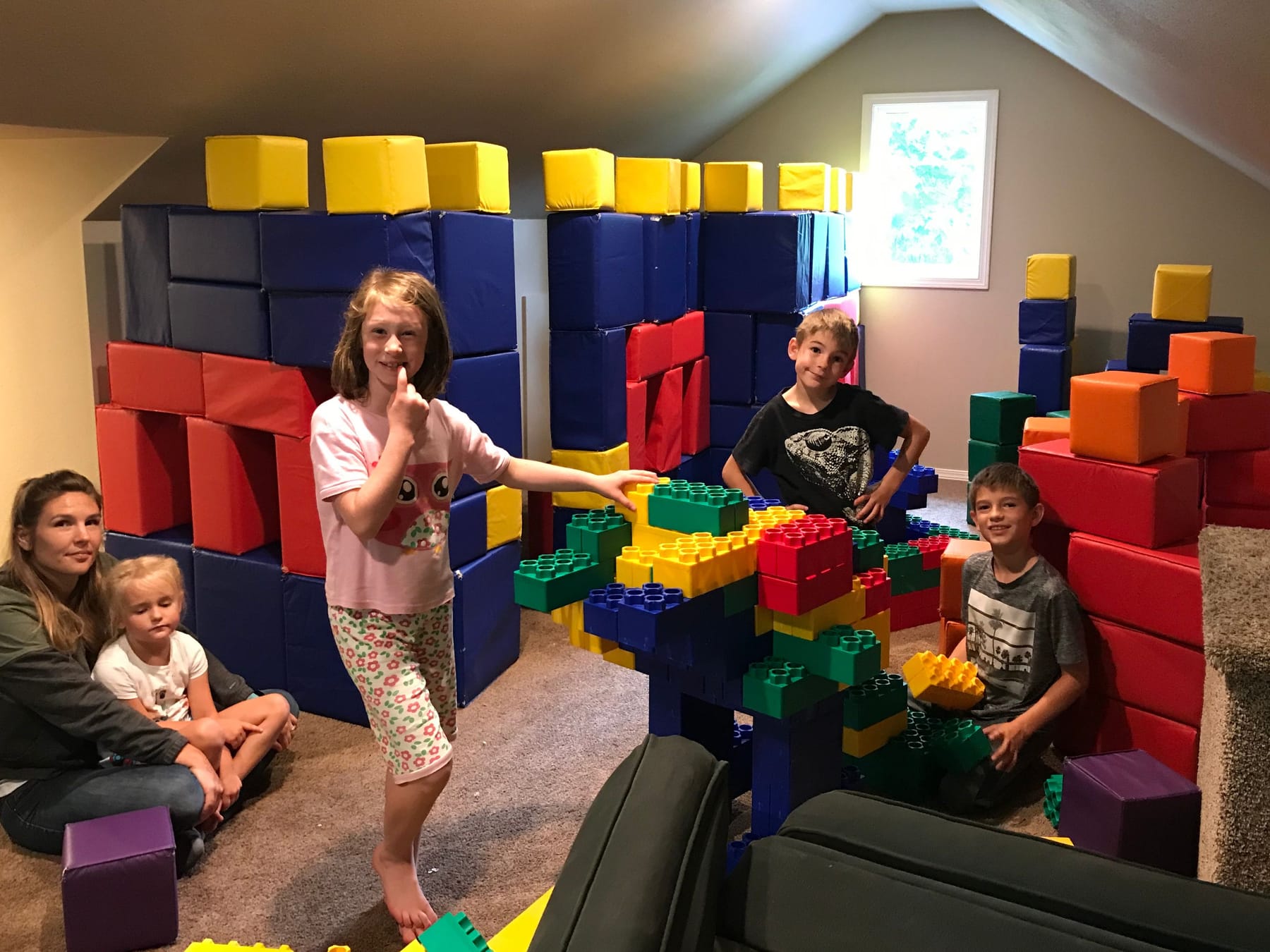 Kids and an adult in the soft-block and LEGO room